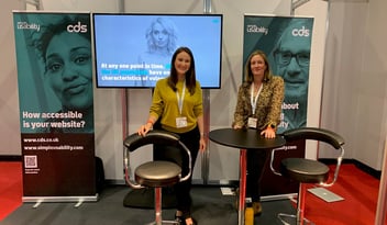Two members of the CDS team standing in front of the CDS stand at Naidex.