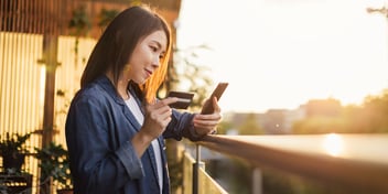 Woman using her phone to purchase items online.
